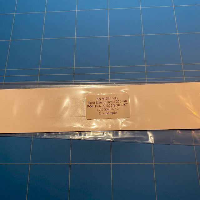 Peach backing card sample in bag on mat
