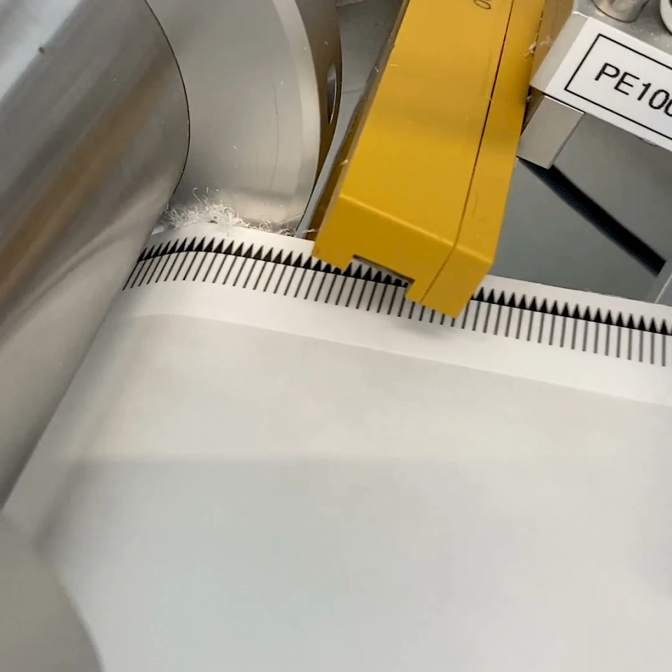 Perforated web through pe1008 guide rollers closeup