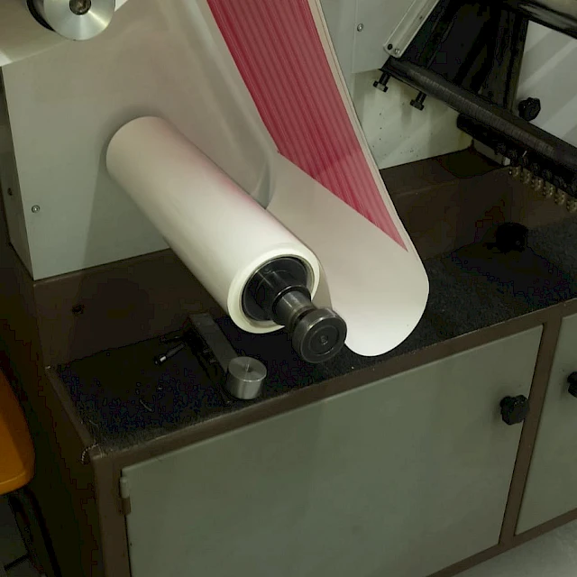 Pink printed web on label press rewind