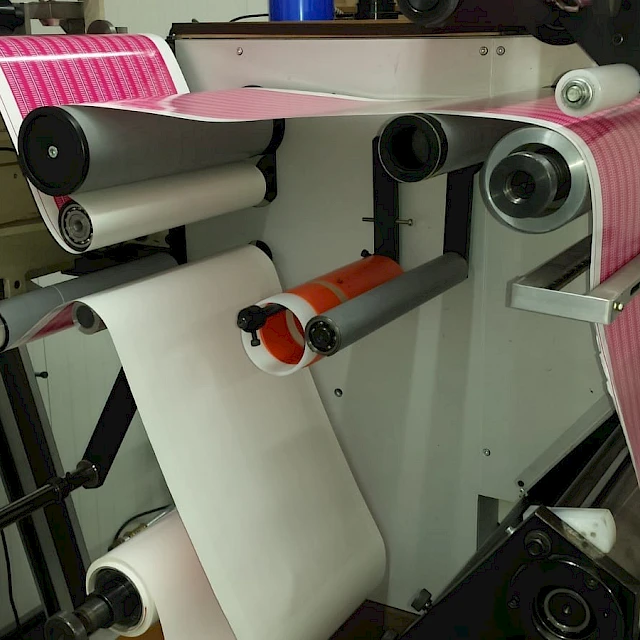 Pink printed web running through press