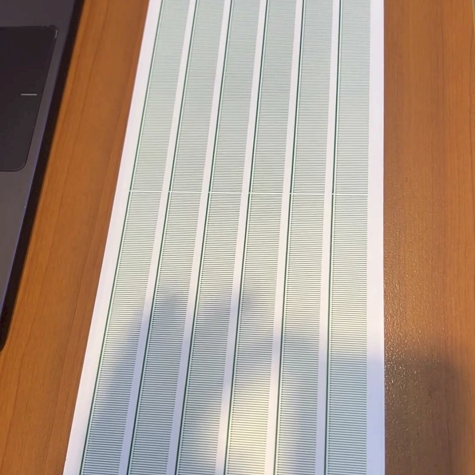Printed scale card on wooden desk sunlight