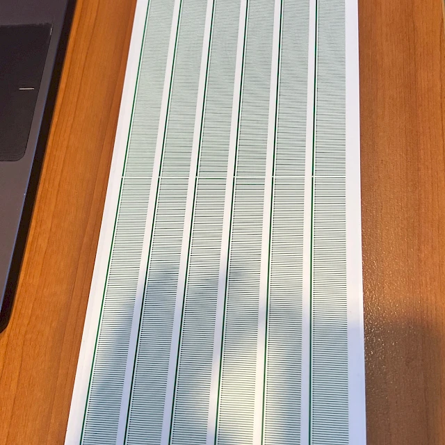 Printed scale card on wooden desk sunlight