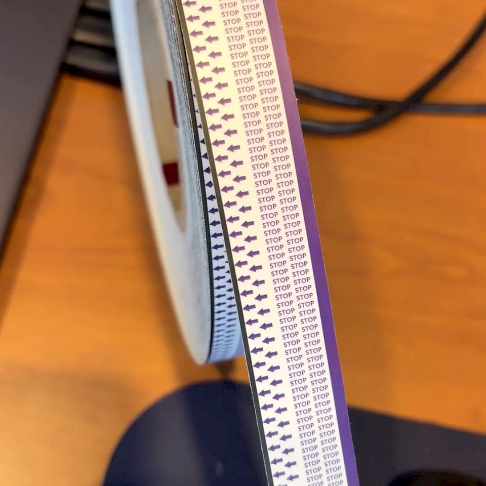 Purple stop arrow printed tape roll