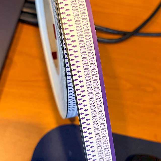 Purple stop arrow printed tape roll