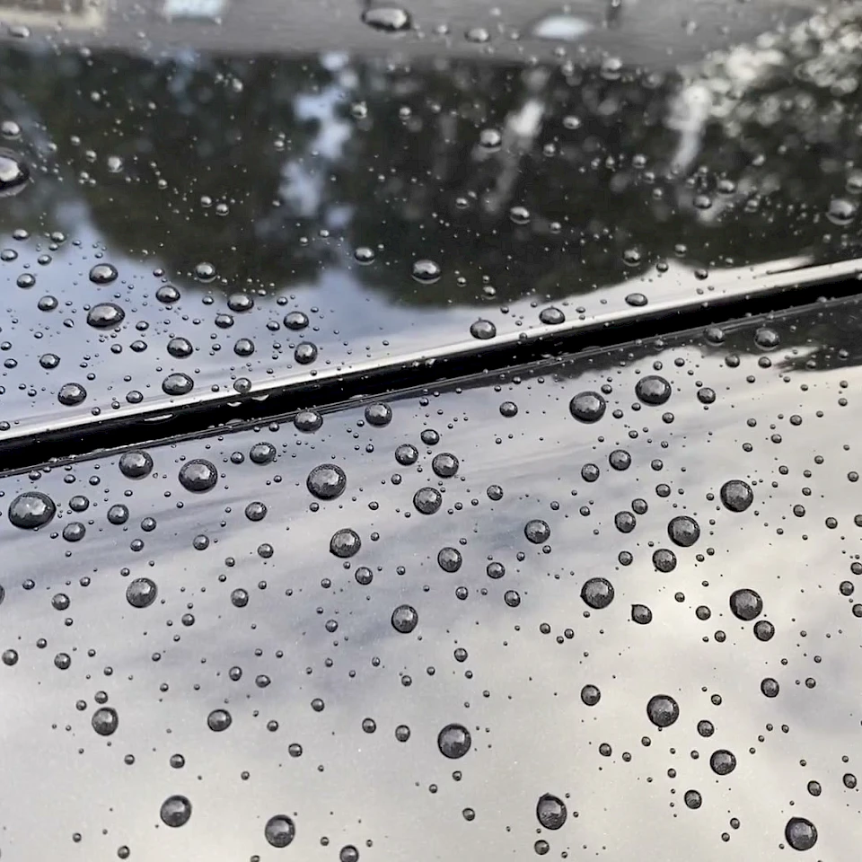 Raindrops on dark car bodywork