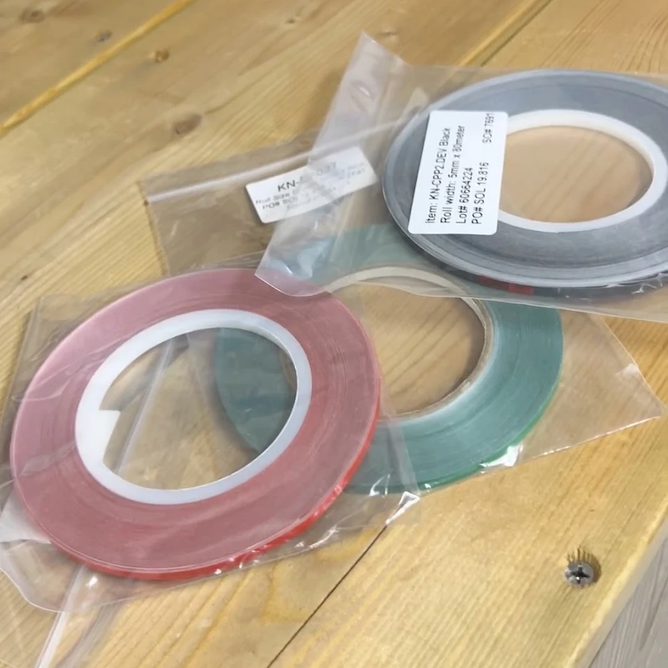 Red green grey narrow tape rolls in bags