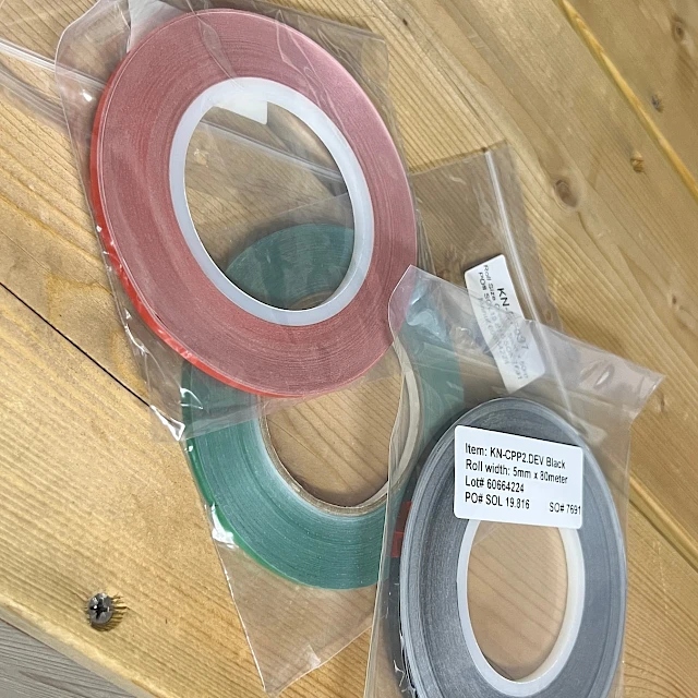 Red green grey narrow tape rolls in bags