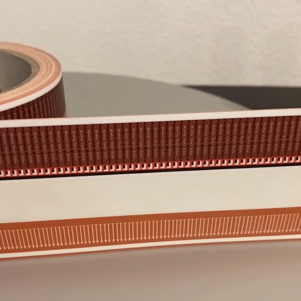 Red printed tape web close up on roller