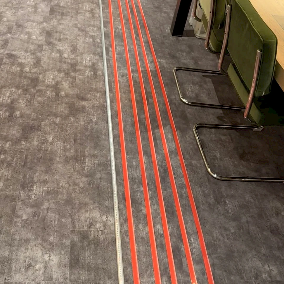 Red tape strips laid on office floor