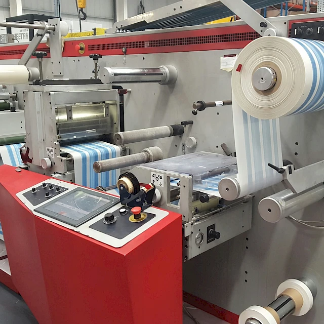 Rotary die cutting press with blue roll