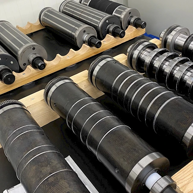 Rotary die cylinders on wooden racks