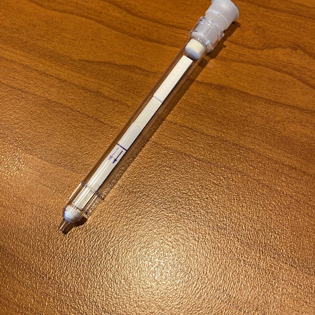 Sample collection swab device on wooden table
