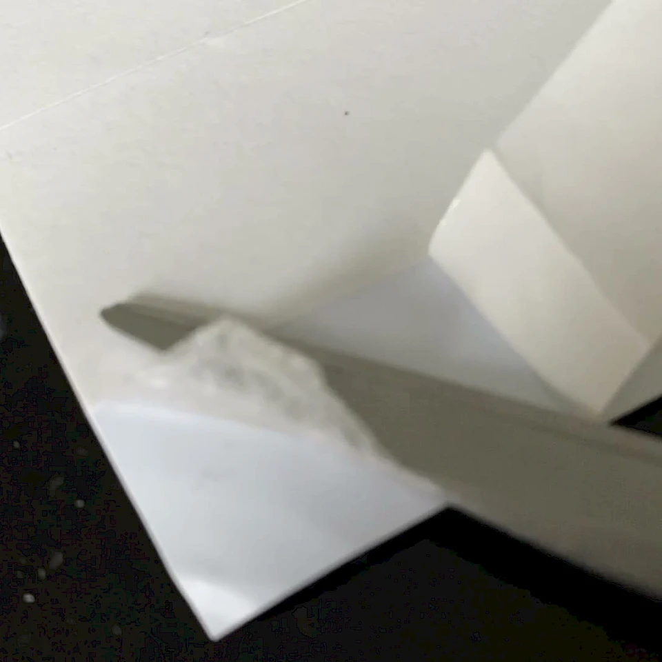 Scissors cutting adhesive card corner