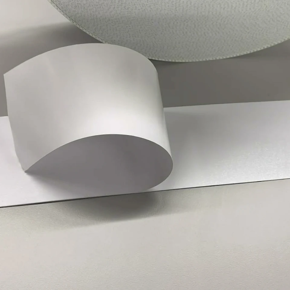 Silver grey film sample curled on bench
