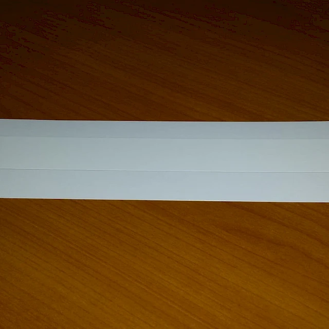 Single white laminated card on wooden table