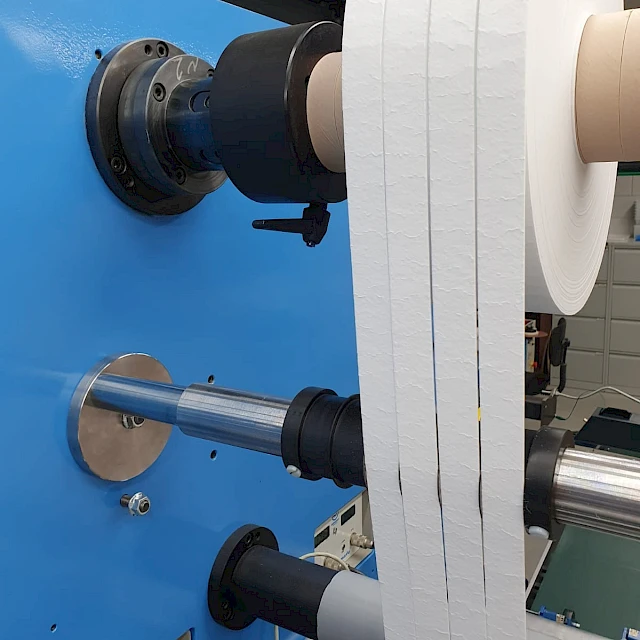 Slit white fibrous webs on rewind shafts