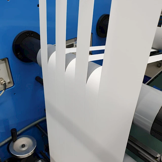 Slit white membrane strips rewinding on blue machine