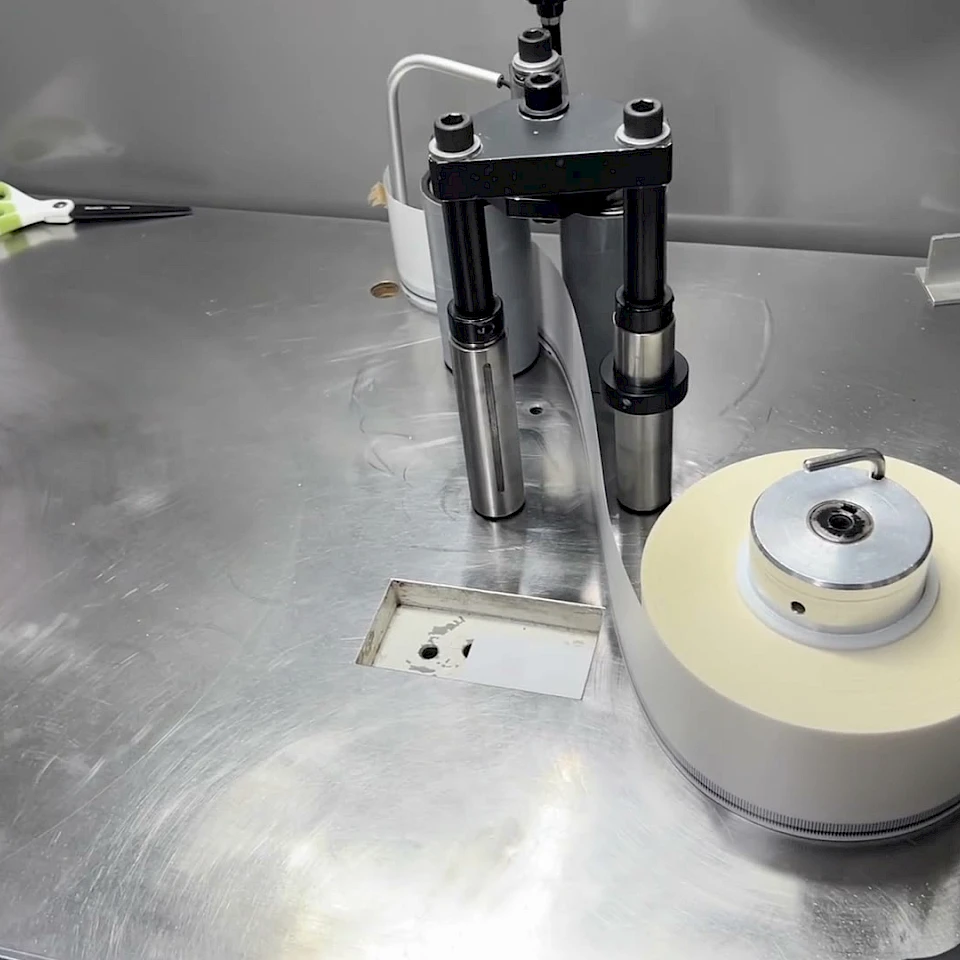 Small roll winding station on steel table