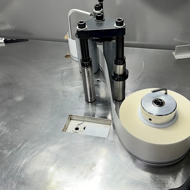 Small roll winding station on steel table