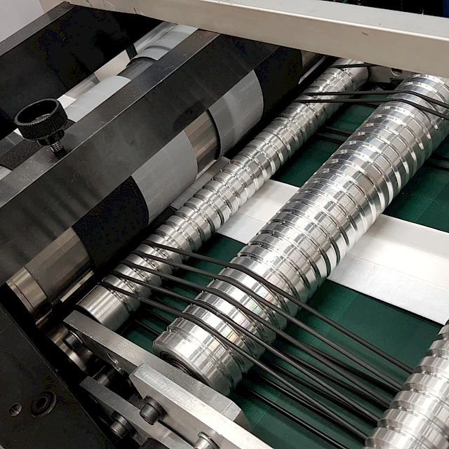 Spiral rollers and cutting unit over white web