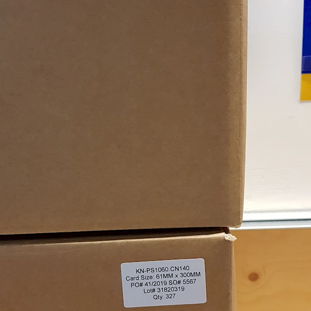 Stacked cartons with backing card labels