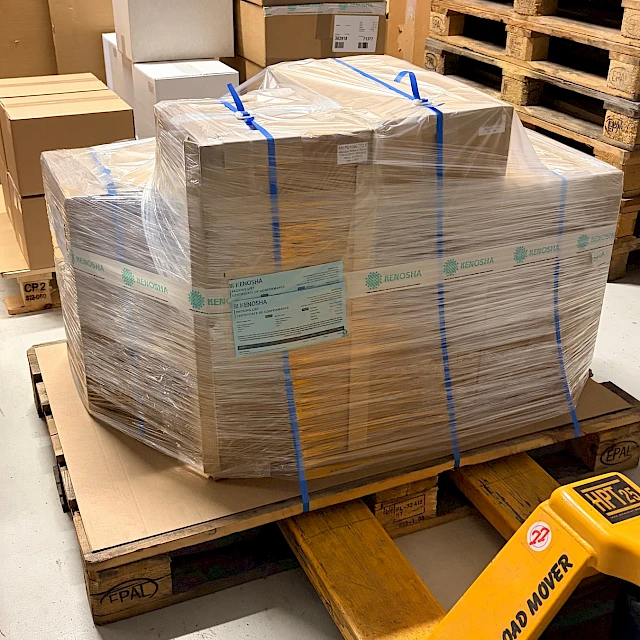 Strapped pallet on pallet jack warehouse