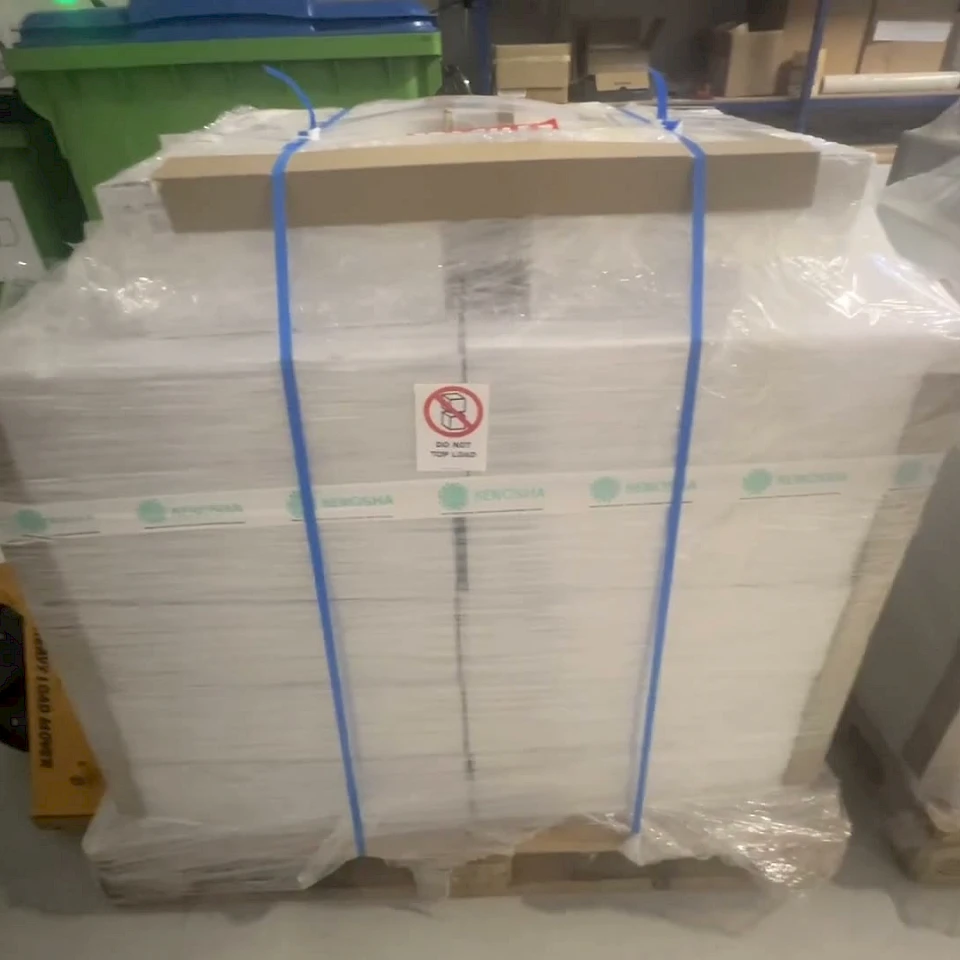 Strapped white sheet pallet with kenosha tape