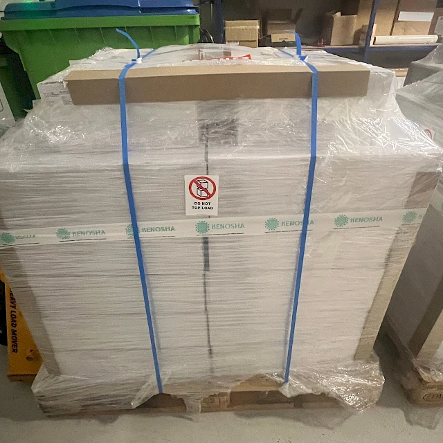Strapped white sheet pallet with kenosha tape