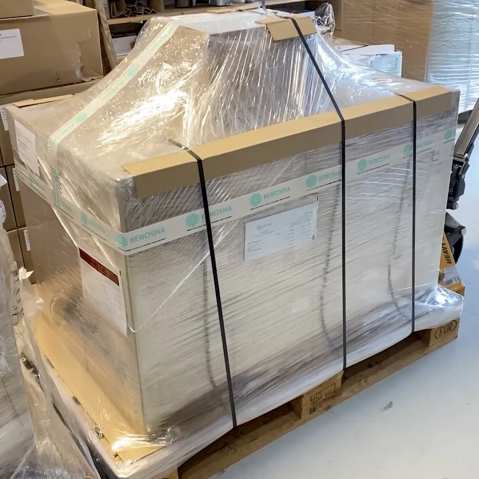 Strapped wrapped pallet of cartons in workshop