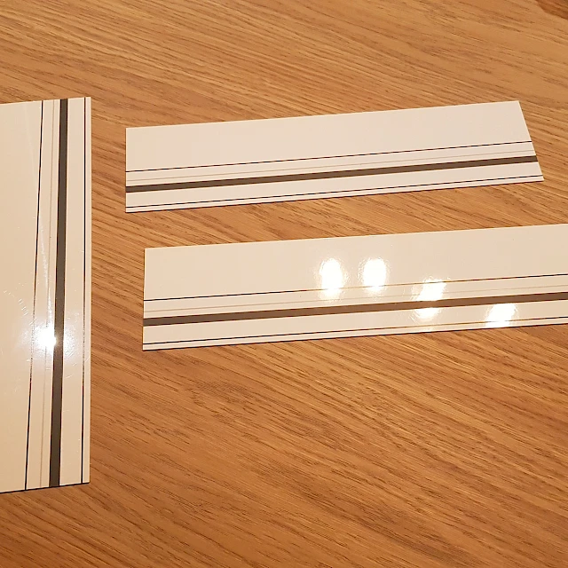 Striped backing card strips on wooden desk