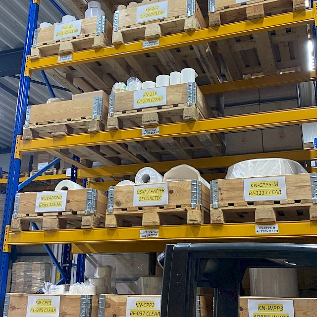 Tall pallet racking with stock and forklift