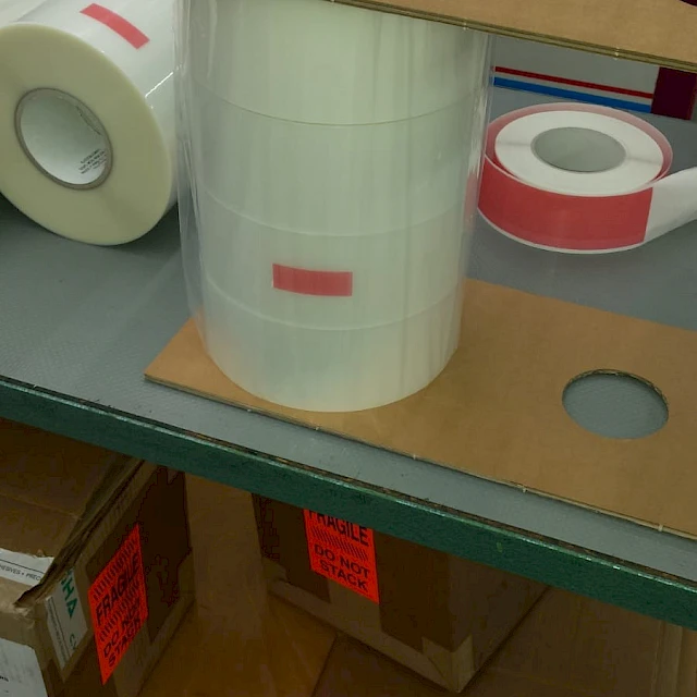 Tape rolls and stacked cores on shelf