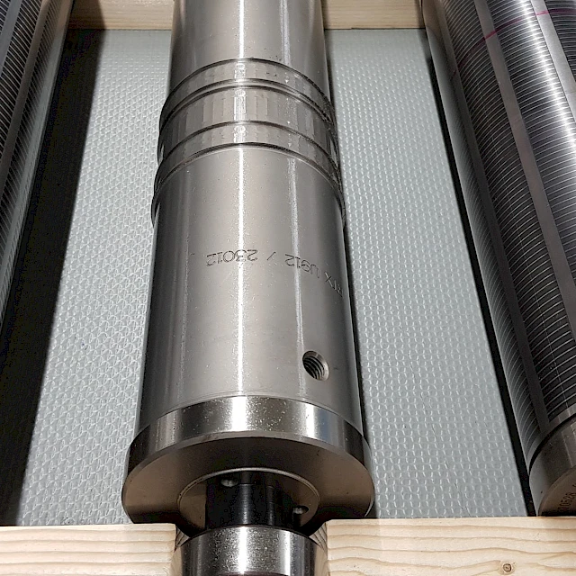 Three rotary die cylinders on wood