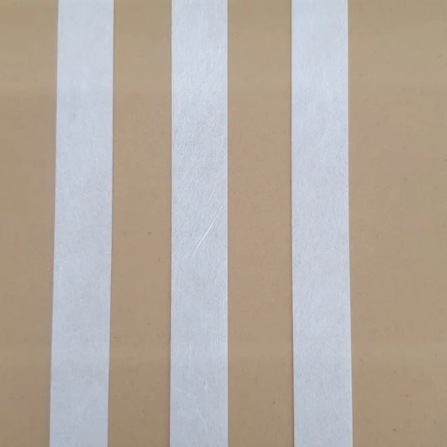 Three white membrane strips on cardboard
