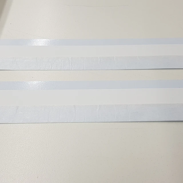 Two backing card strips with adhesive bands