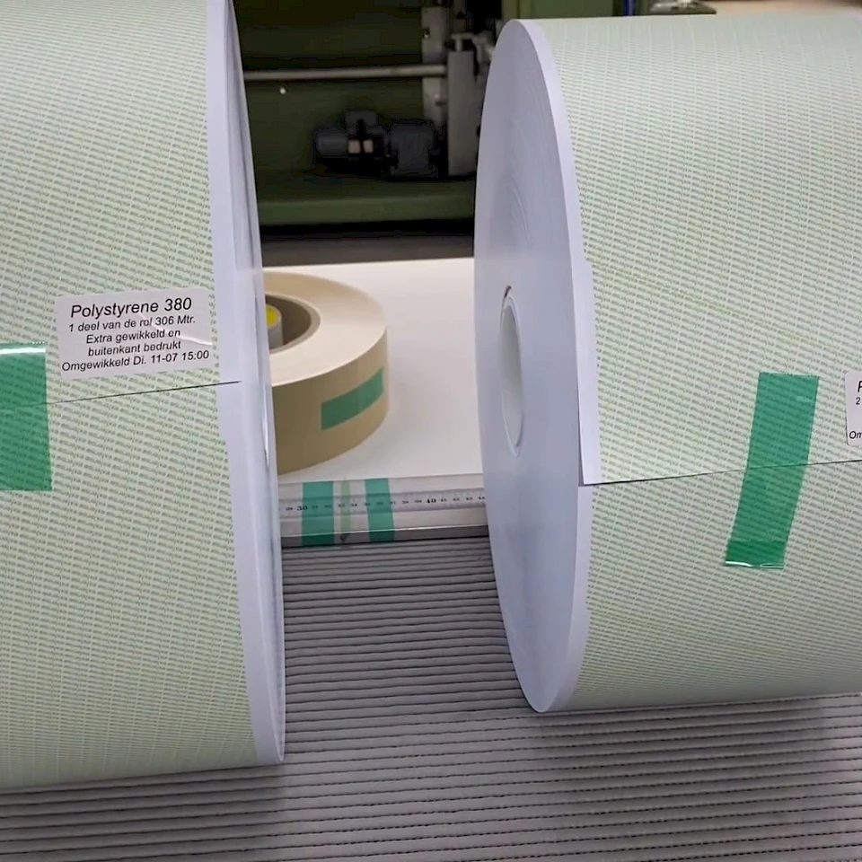 Two green printed polystyrene rolls on mat