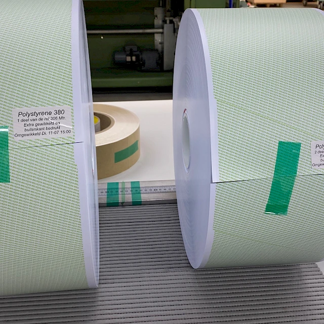 Two green printed polystyrene rolls on mat