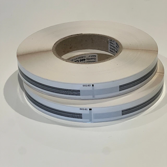 Two printed label rolls stacked on white