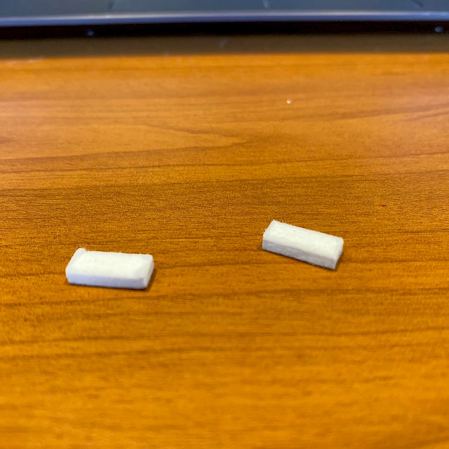 Two small white filter pads on wooden table