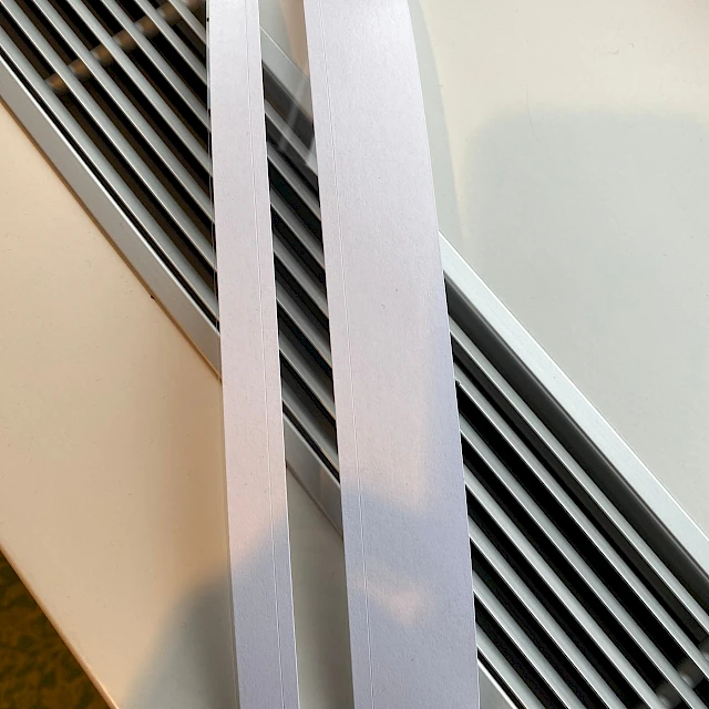 Two white card strips against wall