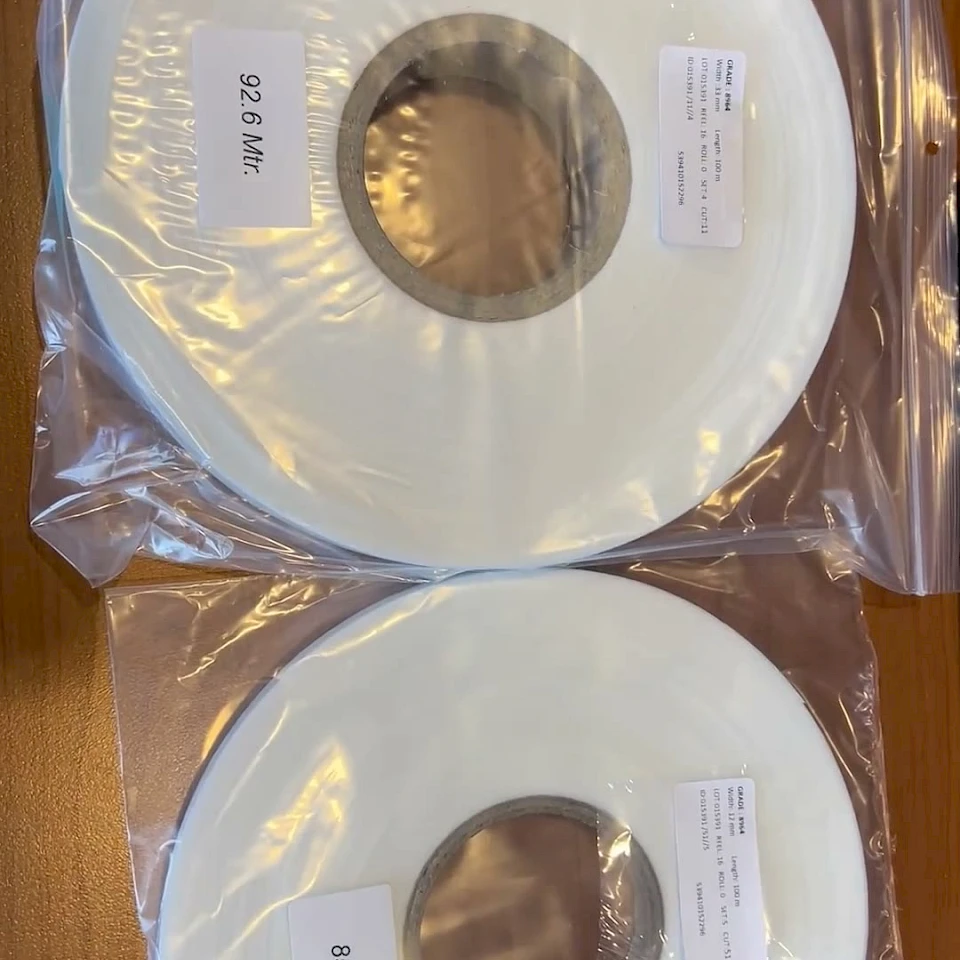 Two white tape rolls in plastic bags