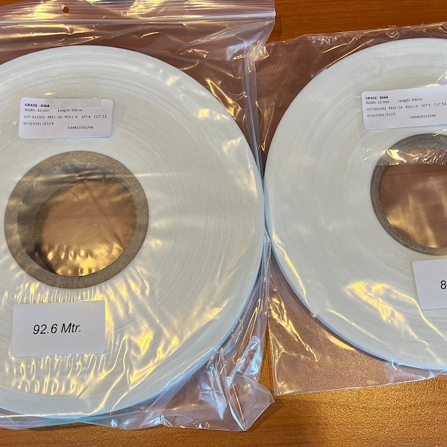 Two white tape rolls in plastic bags