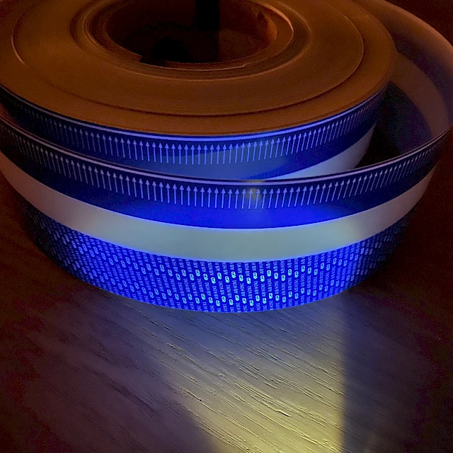 UV lit blue printed tape roll on table