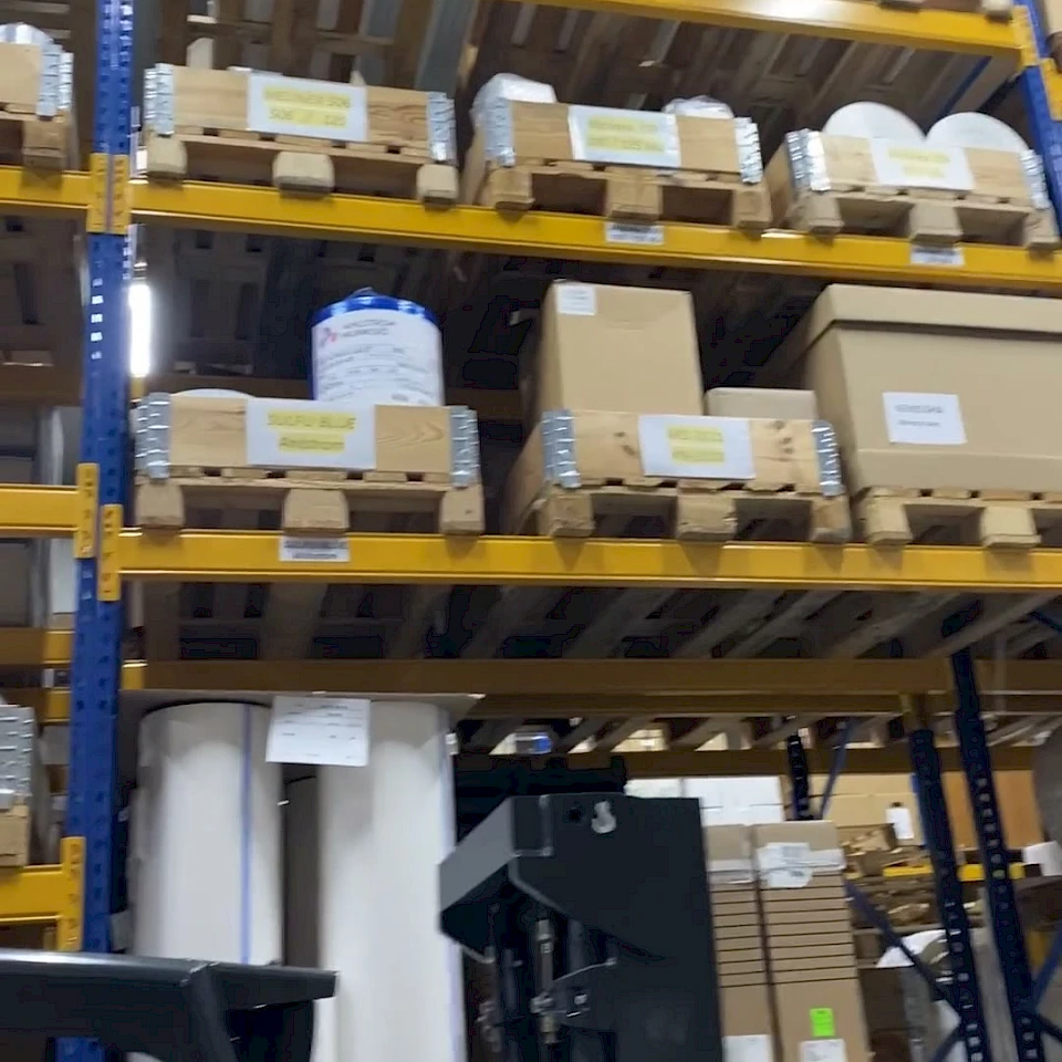 Warehouse racking rolls on pallets with reach truck