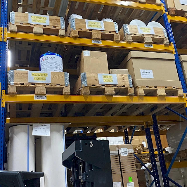 Warehouse racking rolls on pallets with reach truck