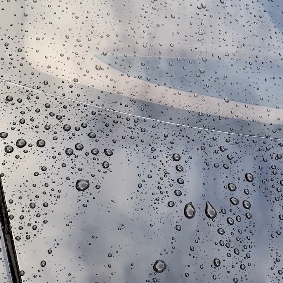 Water droplets on black car paint