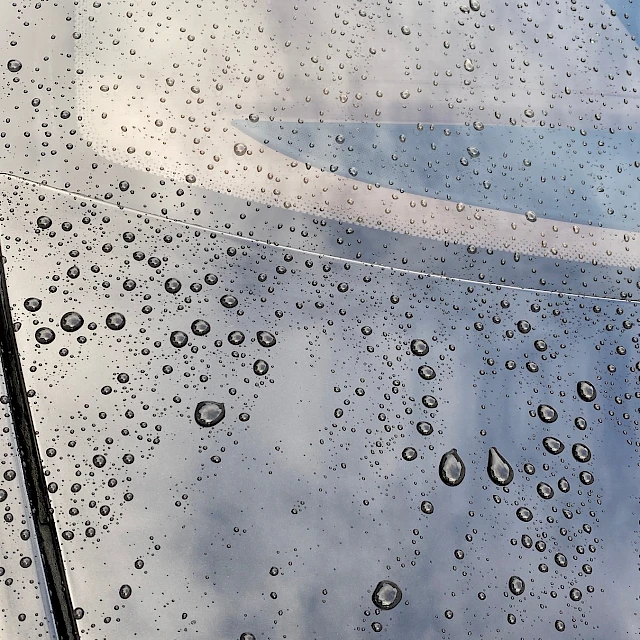 Water droplets on black car paint