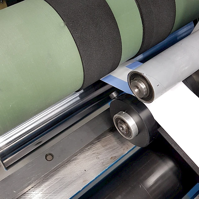 Web on slitter rollers closeup