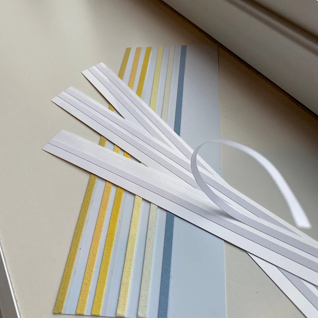 White and yellow card strips on sill