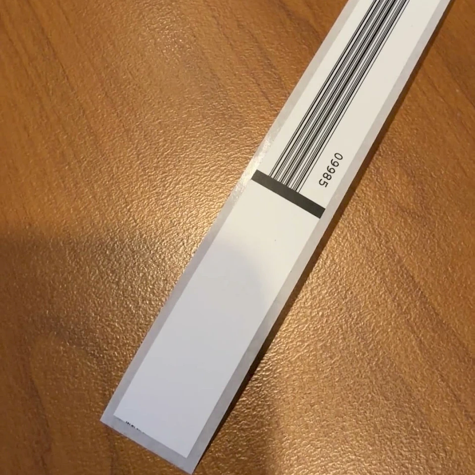White backing card with black stripes on desk